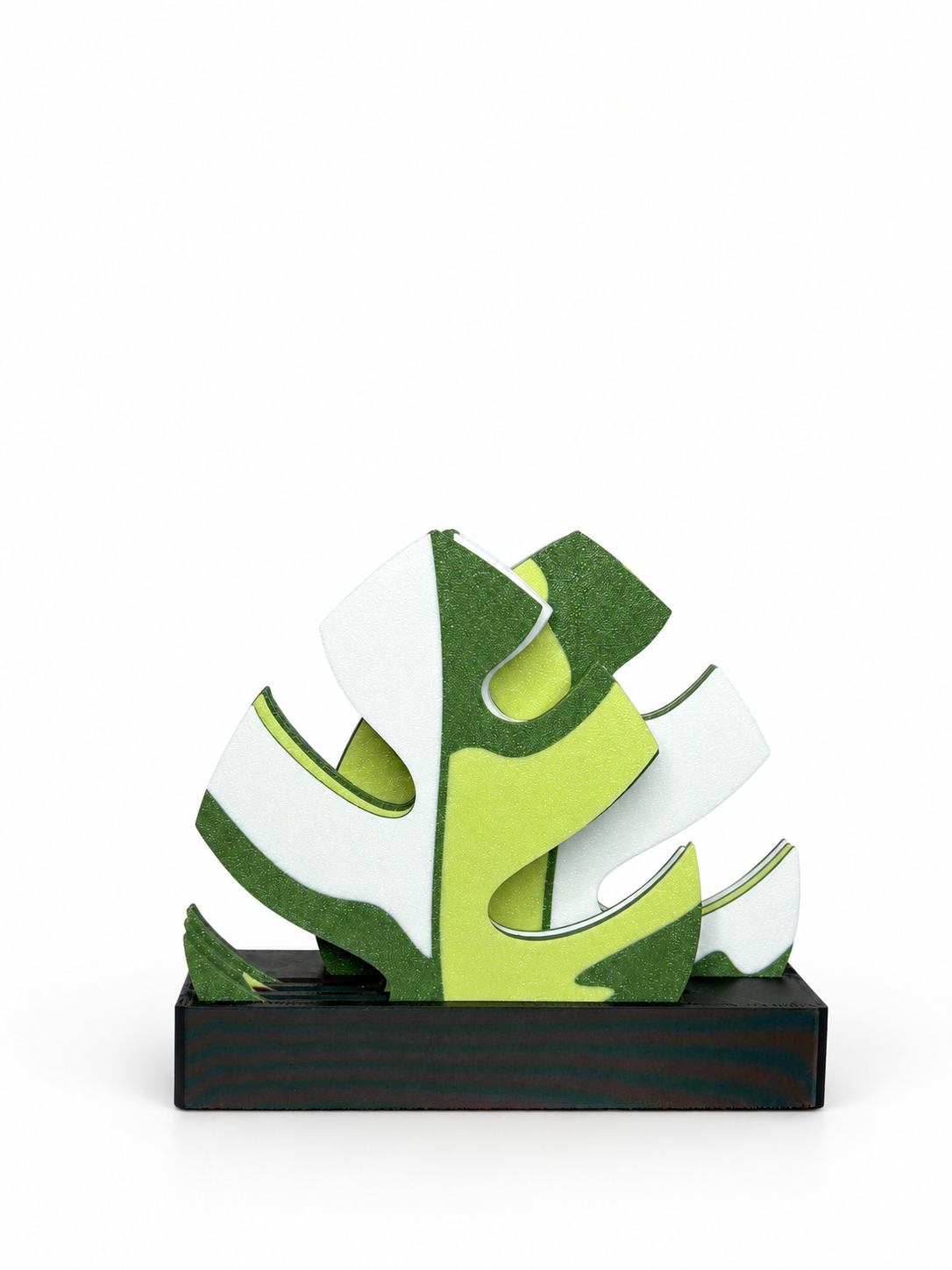 Light green, forest green and white Mini Monstera coasters in a black split holder on a white background.